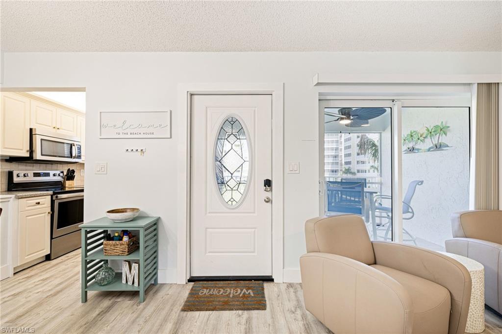 Image 4: Foyer featuring light wood-style flooring, a textured ceiling, and a ceiling fan
