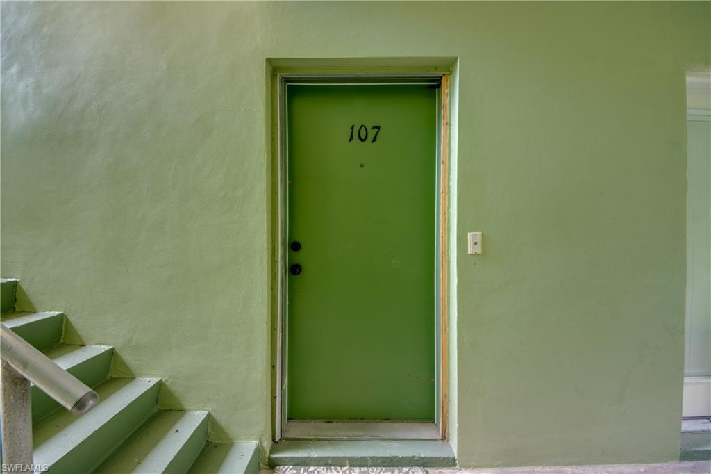 Image 4: Green painted entry door with unit number 107