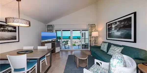 Image 4: Living area with high vaulted ceiling and light tile patterned floors