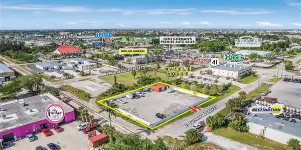 Image 2: Aerial view of property's location featuring property boundaries highlighted and a commercial area