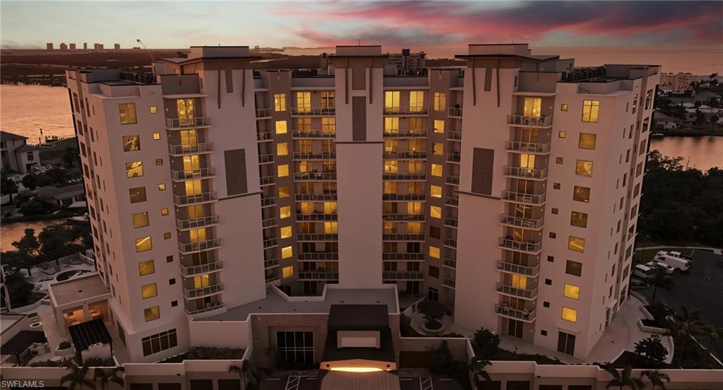 Image 4: View of apartment building / complex featuring a water view - Virtually Edited Image