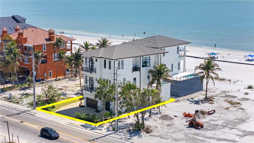 Image 2: Birds eye view of property featuring a water view and a view of the beach - VIRTUALLY EDITED