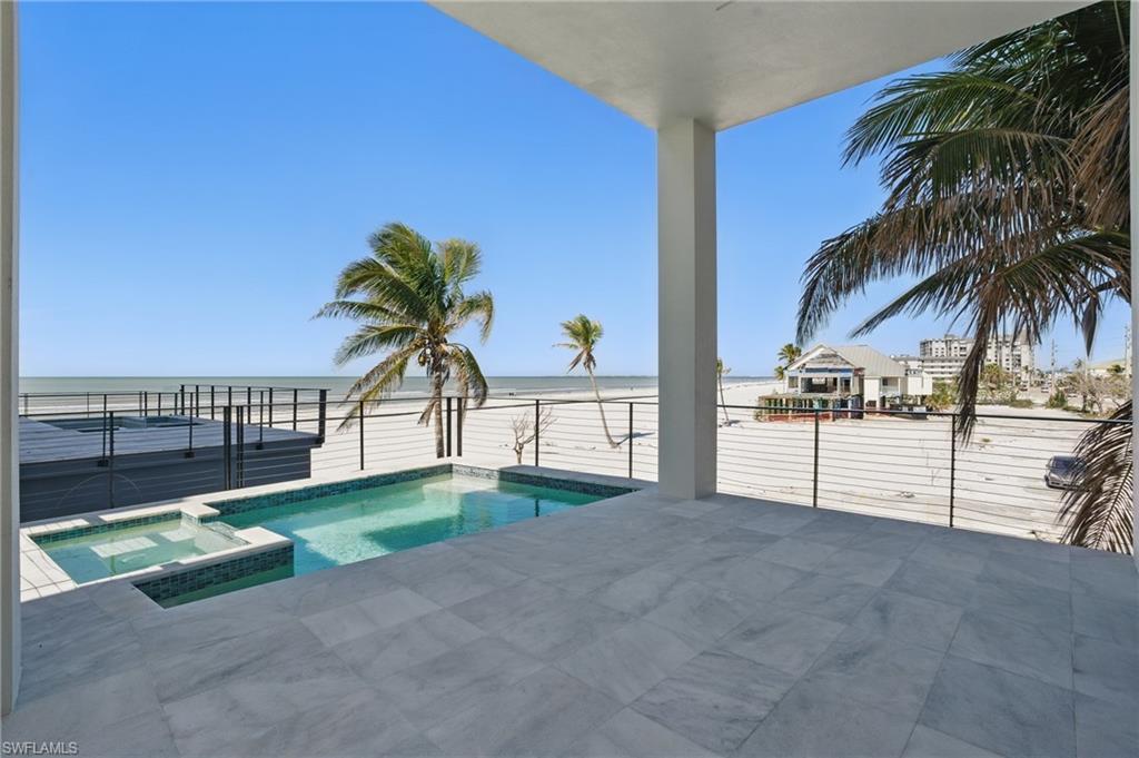 Image 4: View of pool with a pool with connected hot tub and a water view - VURTUALLY EDITED