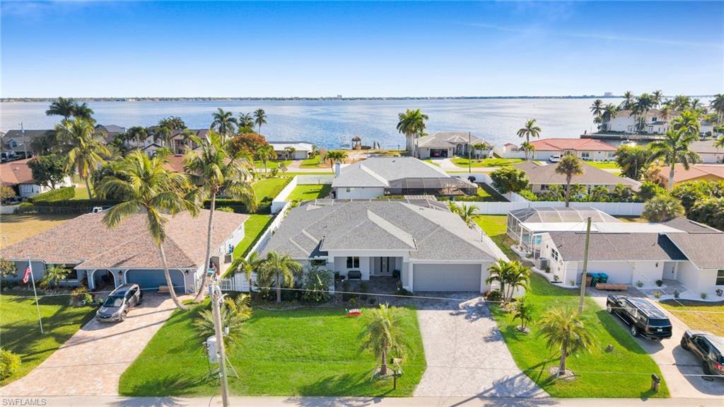 Image 1: Aerial view of residential area with a large body of water