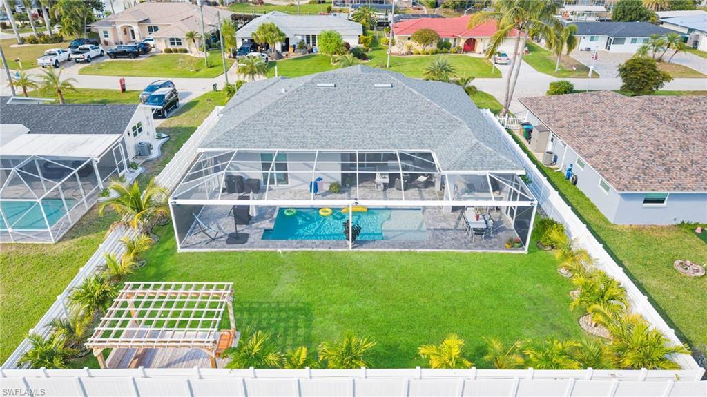 Image 4: Aerial view of residential area with a pool area