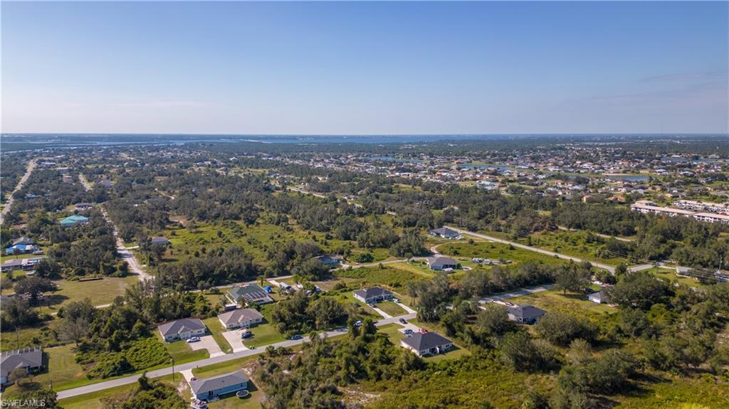 Image 3: Aerial view of property and surrounding area with nearby suburban area