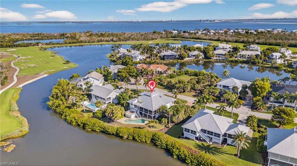 Image 2: Aerial view of residential area with a nearby body of water