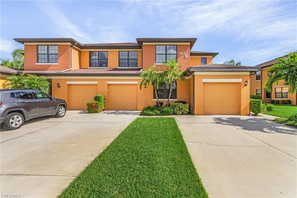 Image 1: View of front of house with a front yard and a garage