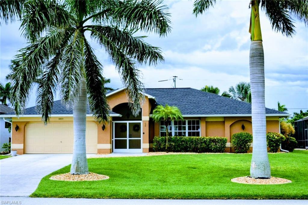Image 1: Single story home featuring a front lawn, roof with shingles, and stucco siding
