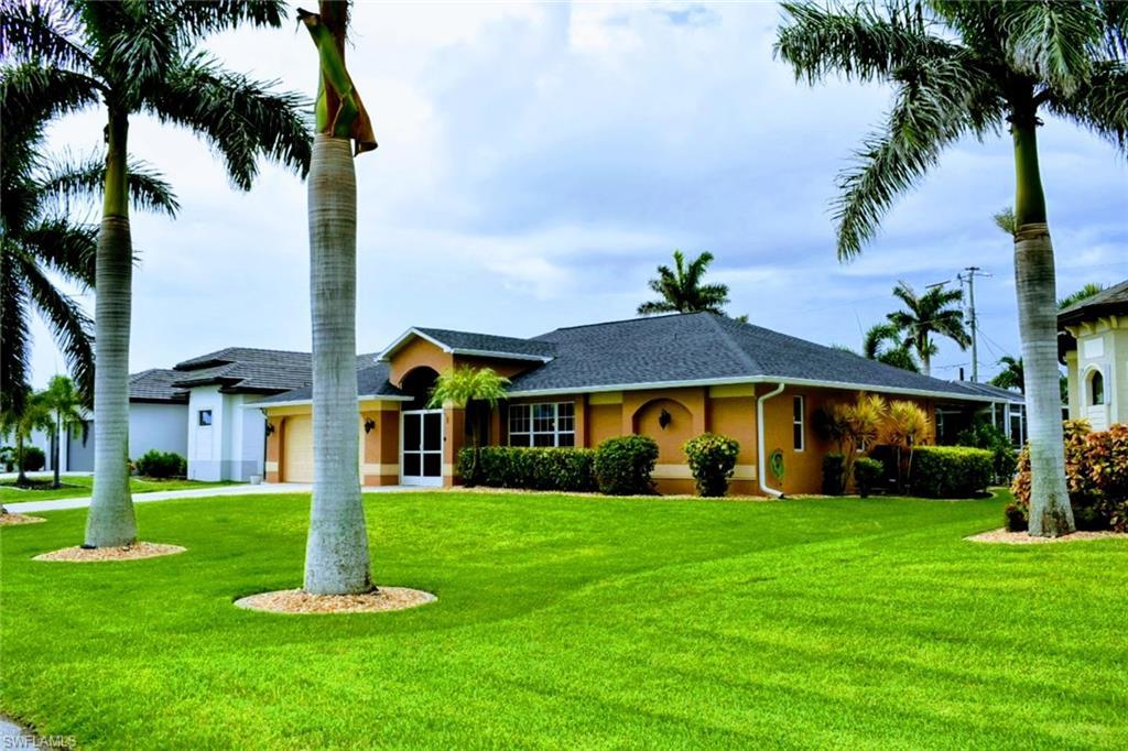 Image 2: Single story home featuring a front lawn, stucco siding, a garage, and roof with shingles