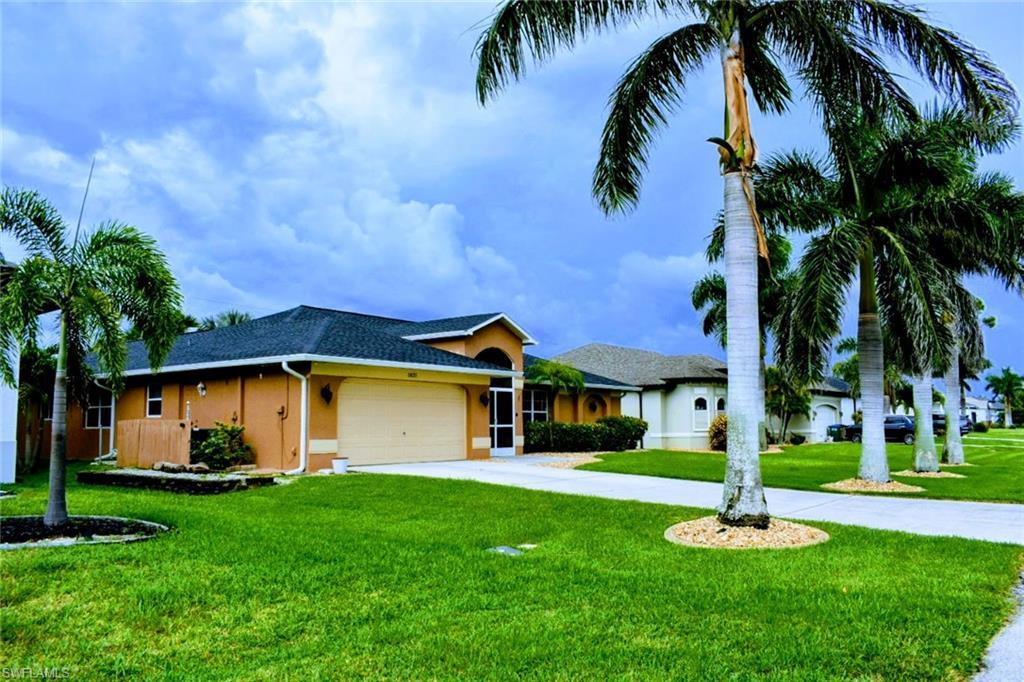 Image 3: Single story home with concrete driveway, stucco siding, a front lawn, an attached garage, and roof with shingles