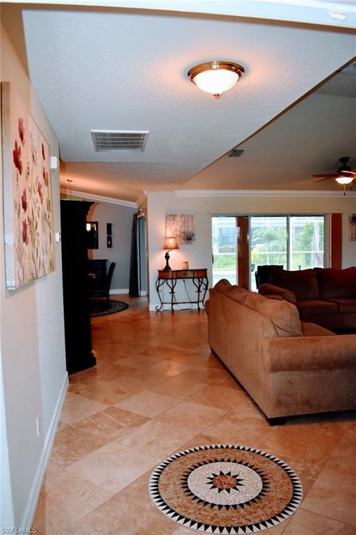 Image 4: Living area with ornamental molding and baseboards