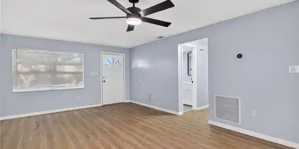 Image 3: Entrance foyer with light wood-style flooring and ceiling fan