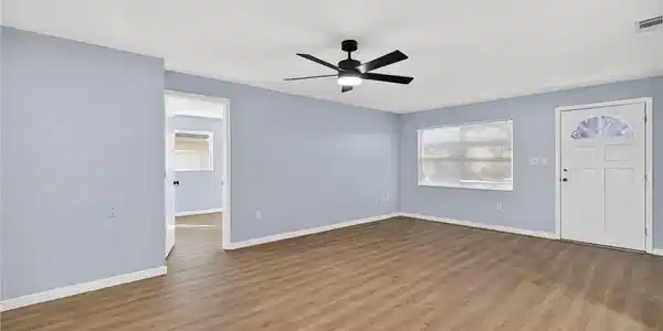 Image 4: Unfurnished living room with a ceiling fan and wood finished floors