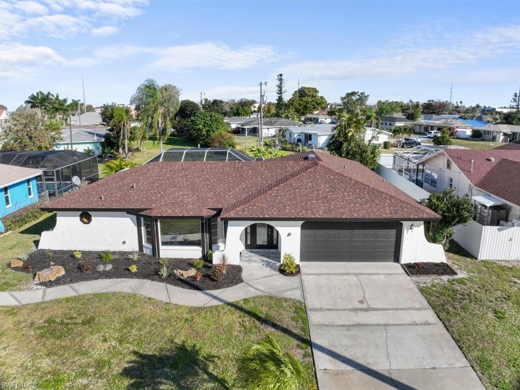 Image 2: Ranch-style house with a front yard, concrete driveway, a garage, and a residential view