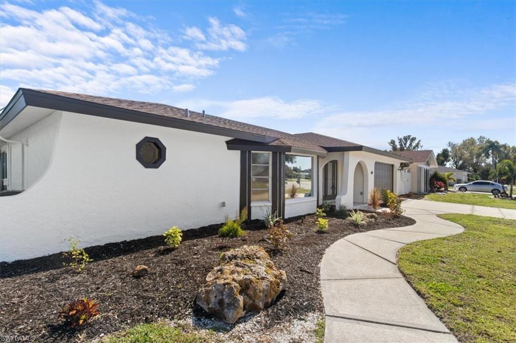Image 4: Single story home with stucco siding, driveway, a garage, and a front yard