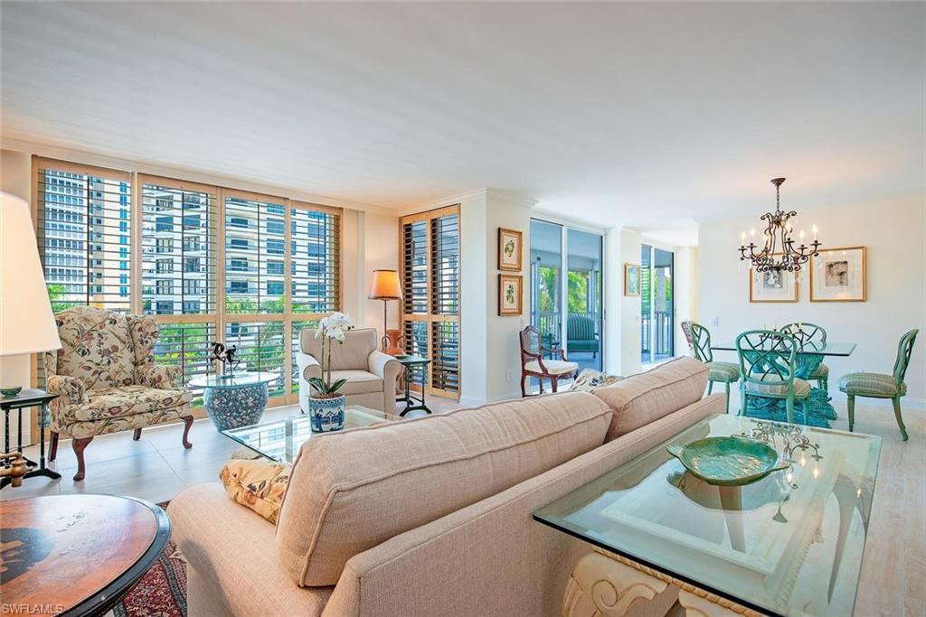 Image 3: Open-concept living and dining area with light-toned flooring