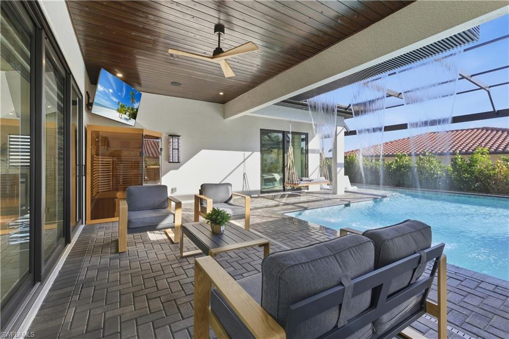 Image 3: View of patio with a ceiling fan, an outdoor lounge area, and an outdoor pool