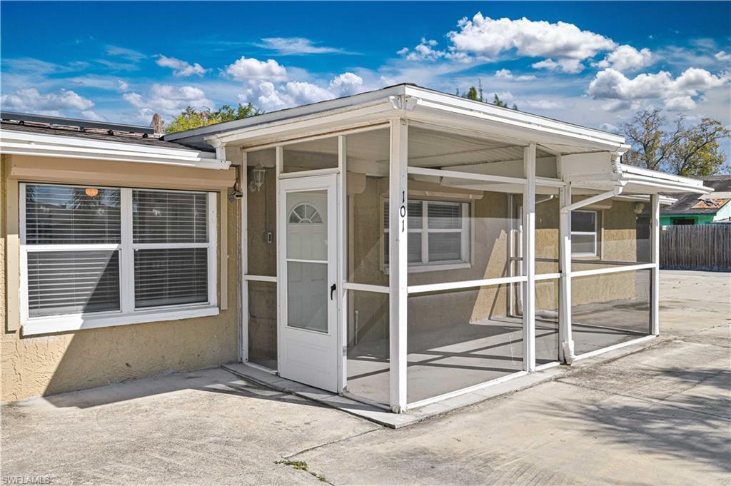Image 4: View of exterior entry with a sunroom and stucco siding
