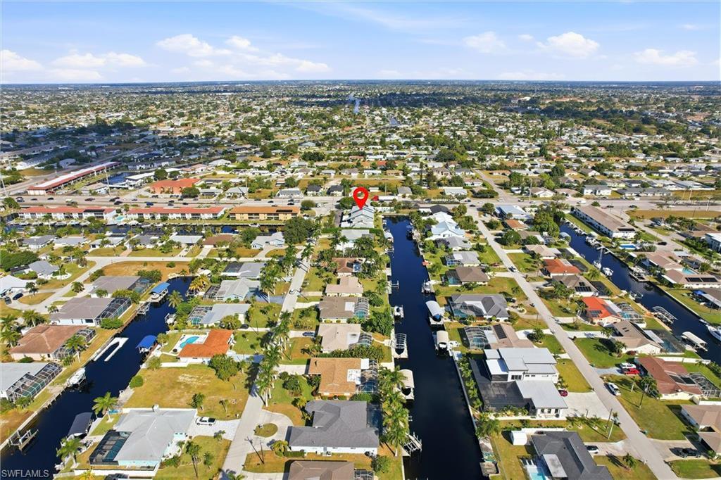 Image 2: Aerial view of property and surrounding area featuring nearby suburban area