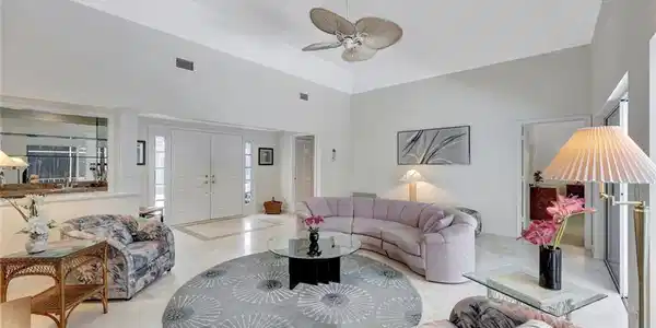 Image 4: Living room with a ceiling fan, high vaulted ceiling, and visible vents