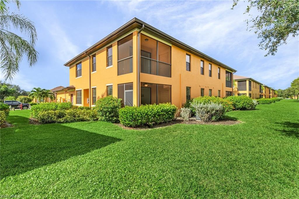 Image 2: Back of property featuring a lawn