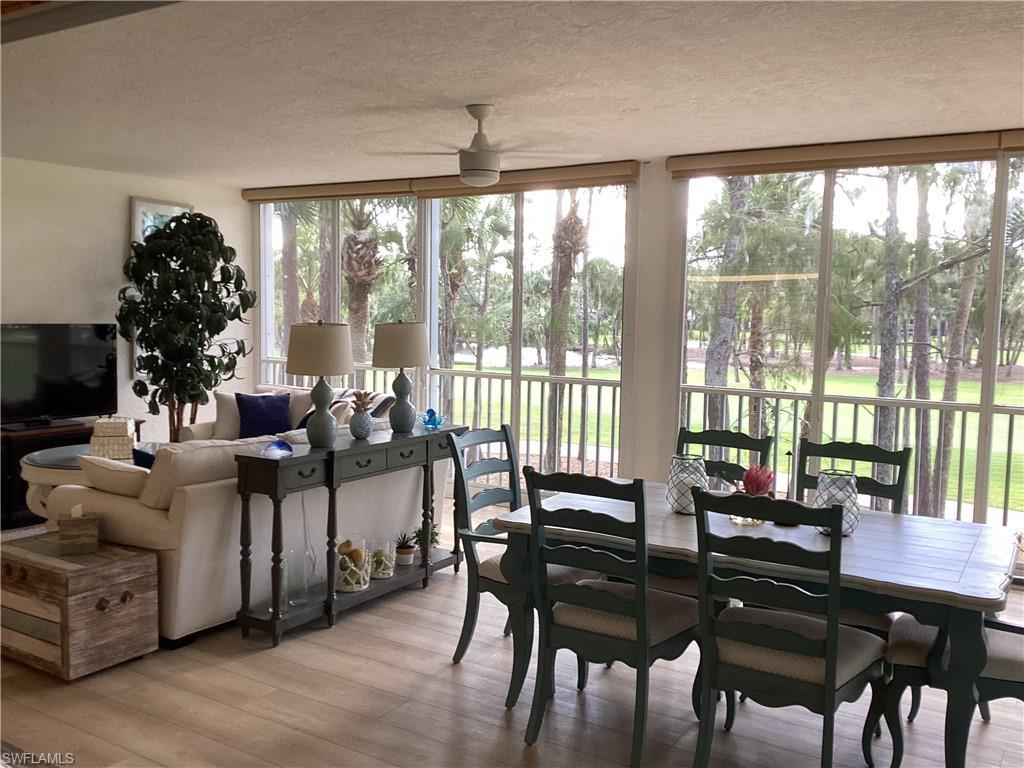 Image 3: Enclosed lanai with a textured ceiling, wood finished floors, and expansive windows