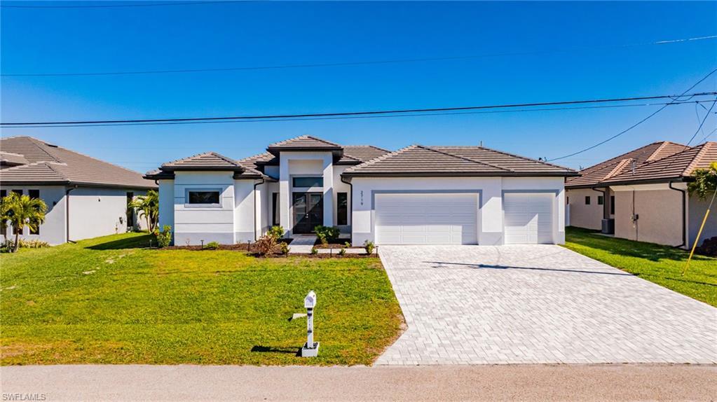 Image 1: Prairie-style house with a front lawn, stucco siding, an attached garage, a tile roof, and driveway