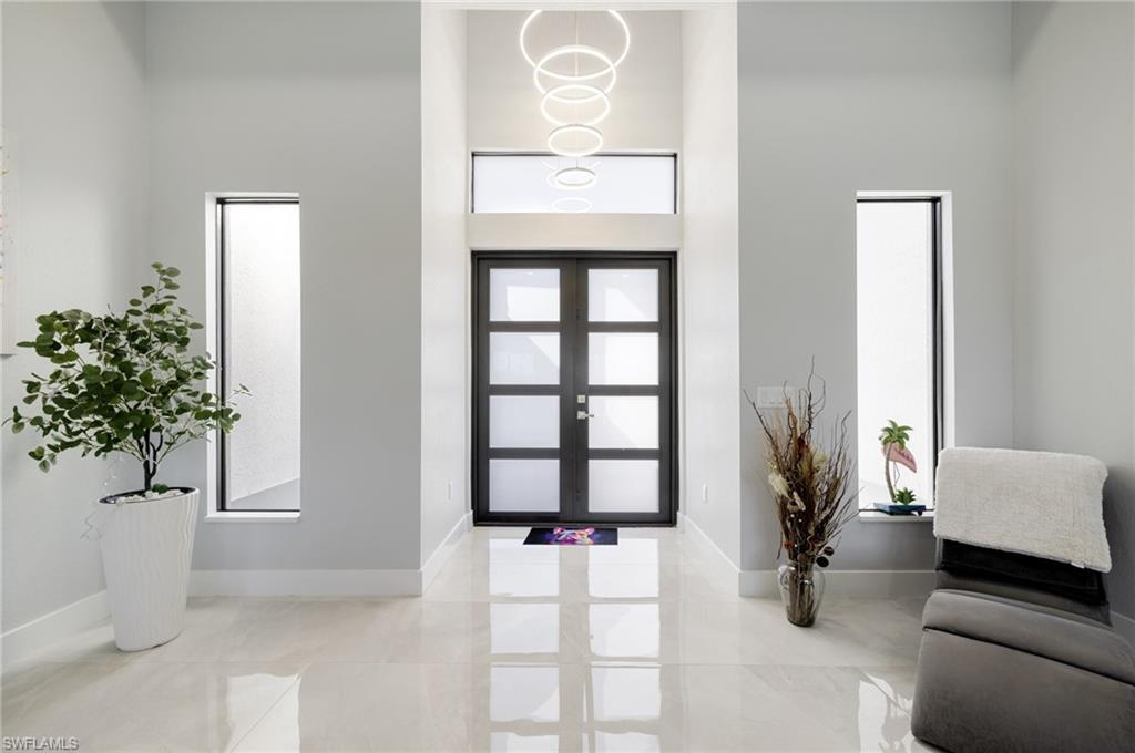 Image 4: Entryway with a high ceiling and french doors