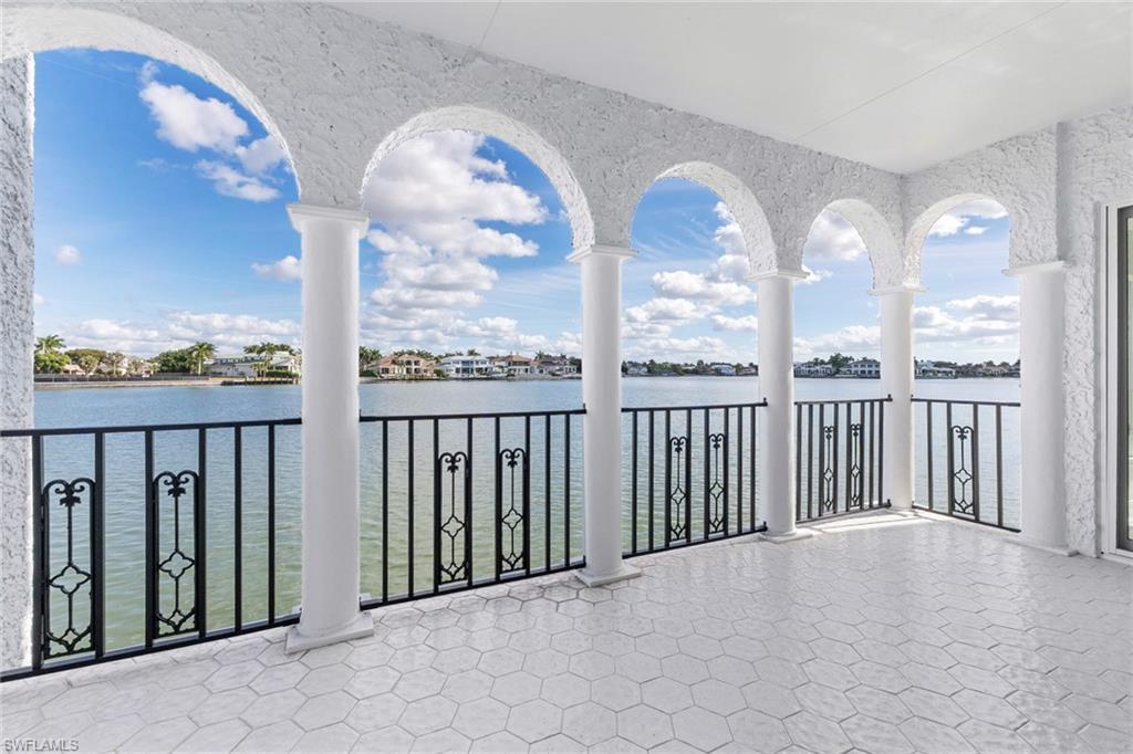 Image 2: Balcony featuring a water view