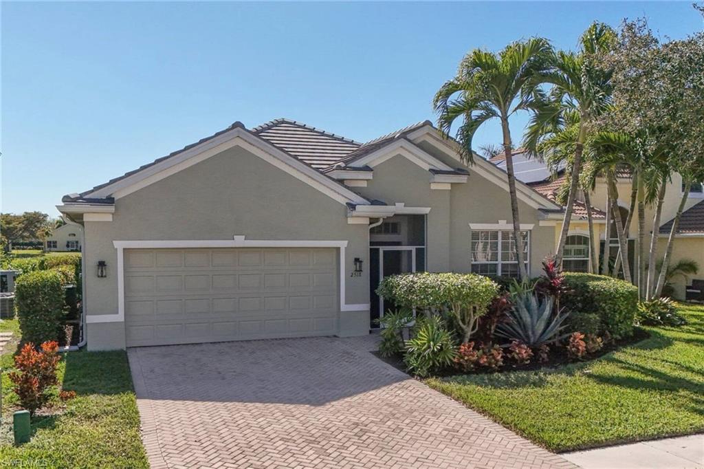 Image 2: Single story home with stucco siding, decorative driveway, a garage, a front yard, and a tile roof