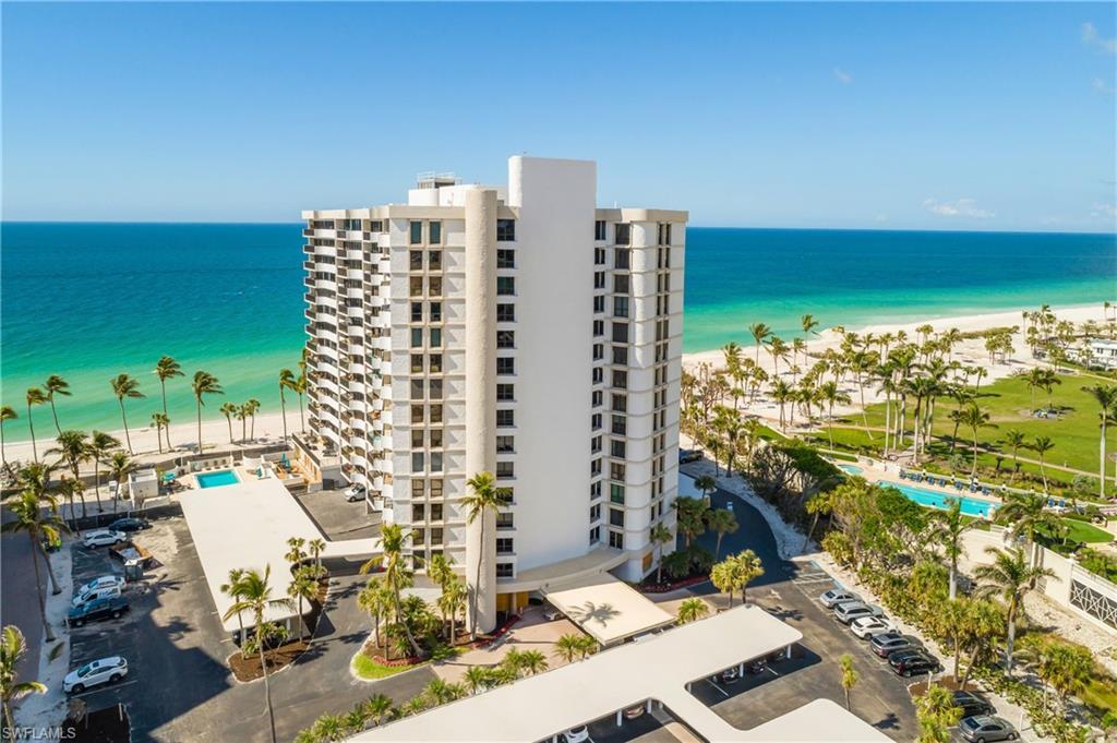 Image 1: Drone / aerial view of apartment complex and waterfront with a beach