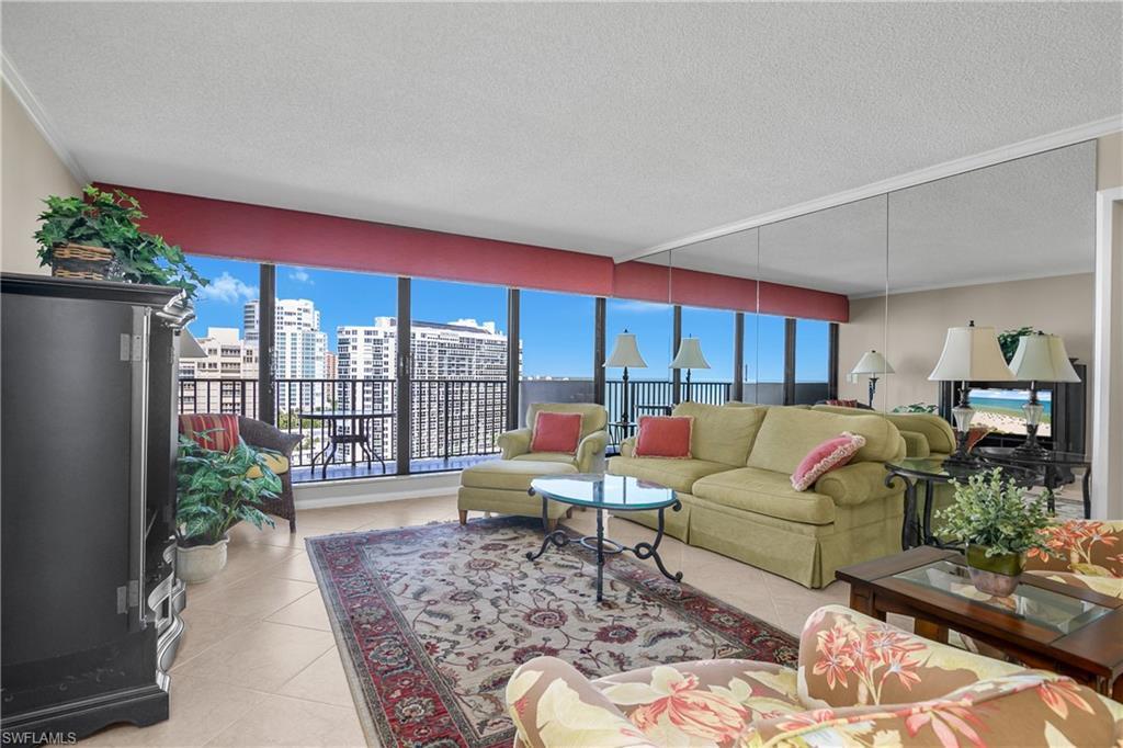 Image 3: Living room featuring light tile patterned floors, a textured ceiling, and a view of city