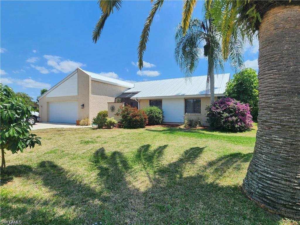 Image 1: Single story home with a garage and a front yard