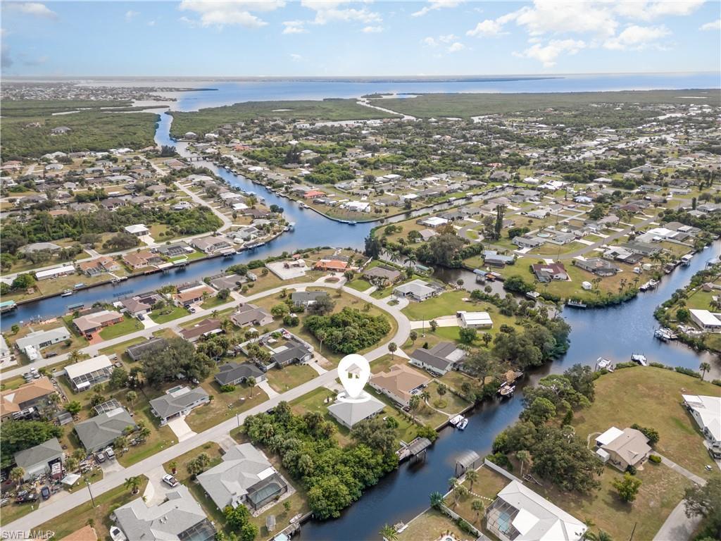 Image 2: View of property location with nearby suburban area and a nearby body of water