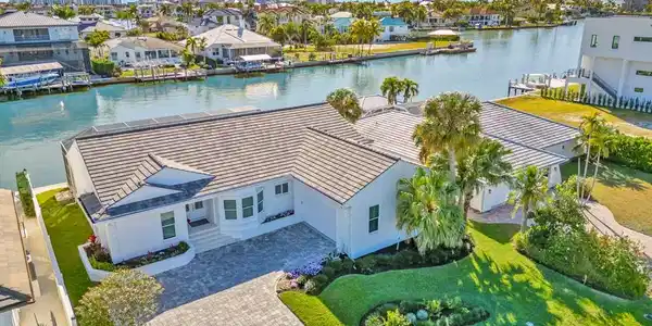 Image 3: Aerial perspective of suburban area featuring a nearby body of water