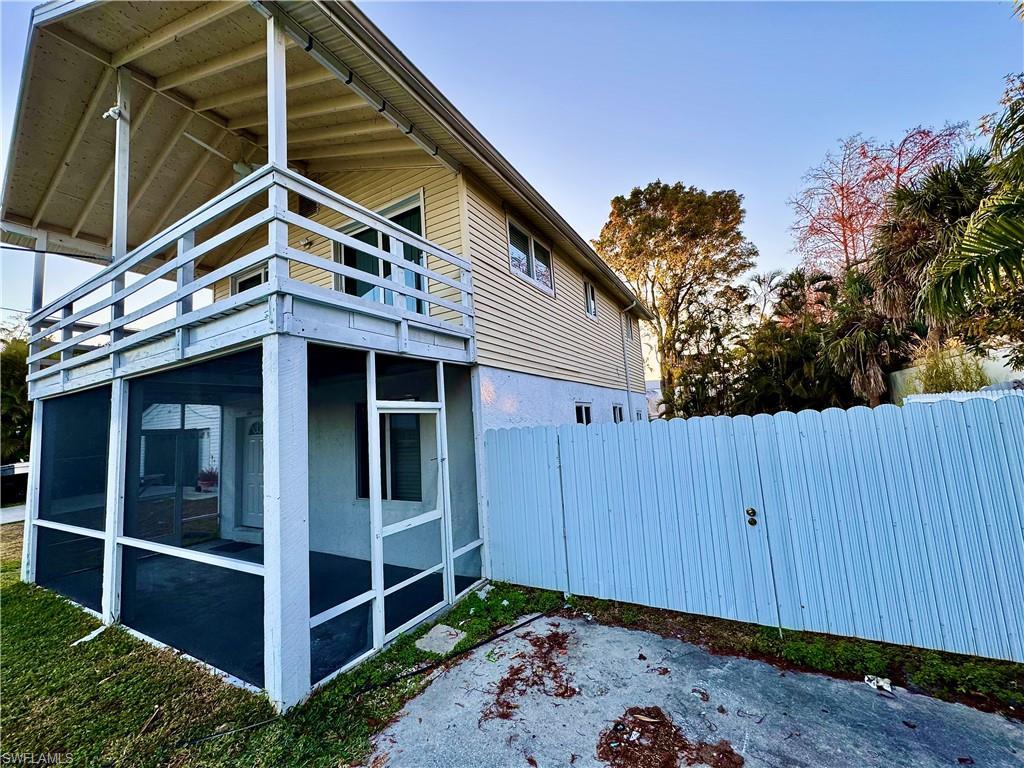 Image 3: View of home's exterior featuring a sunroom and a balcony