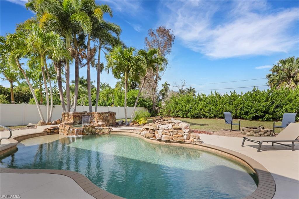 Image 3: View of swimming pool featuring patio surround and a fenced backyard