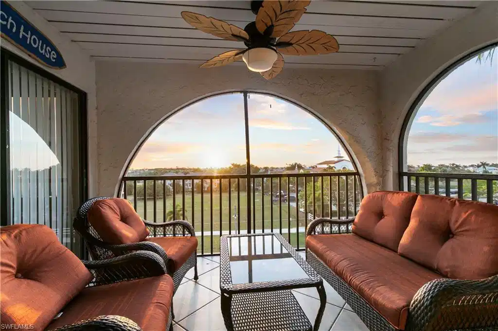 Image 1: Patio terrace at dusk with an outdoor living space, a balcony, and ceiling fan