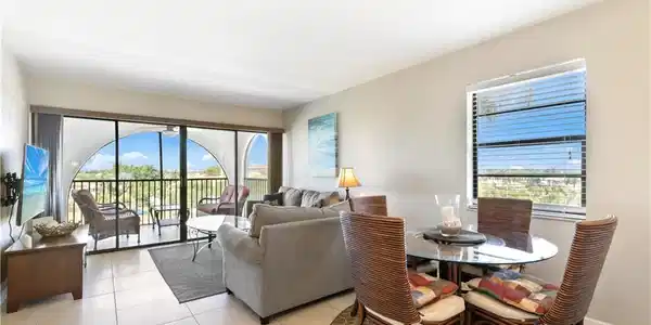 Image 2: Dining room with a healthy amount of sunlight and light tile floors