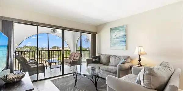 Image 3: Tiled living room with plenty of natural light and ceiling fan