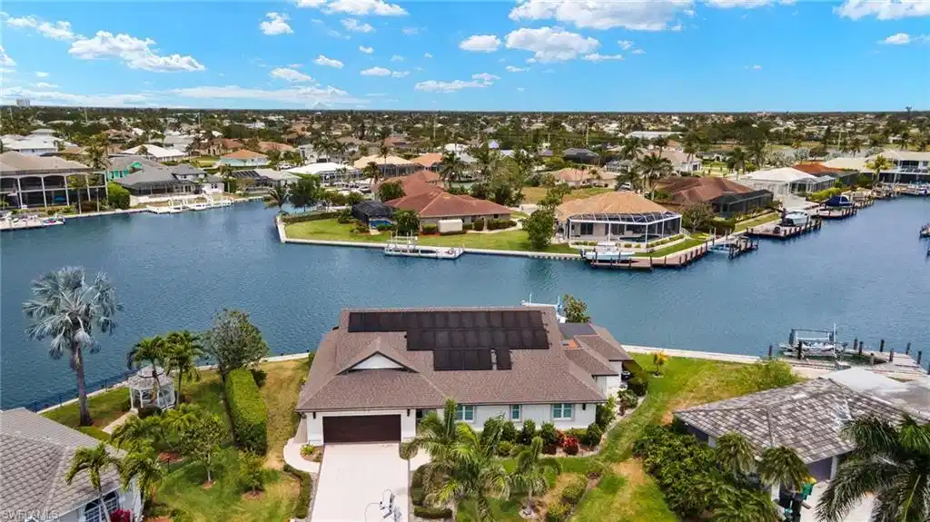 Image 1: Aerial view of residential area with a nearby body of water