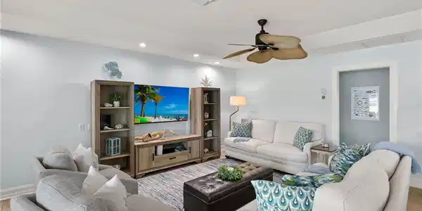 Image 4: Living area with wood finished floors, a ceiling fan, and recessed lighting