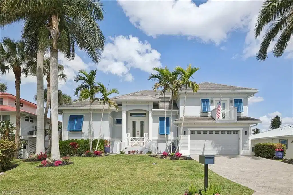 Image 1: View of front of home featuring French doors, and attached 2 1/2 car garage with driveway