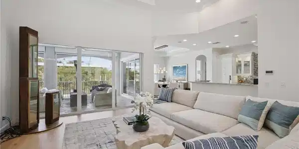 Image 2: Living area featuring a coffered ceiling, ornamental molding, recessed lighting, wood flooring, and a ceiling fan