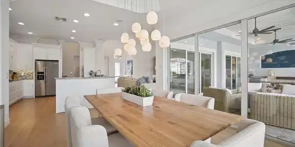 Image 4: Dining area with crown molding, recessed tray ceiling and chandelier