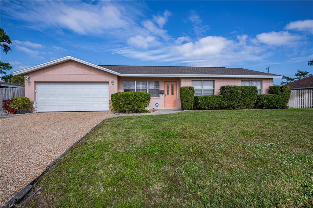 Image 2: Ranch-style house with a garage and a front lawn