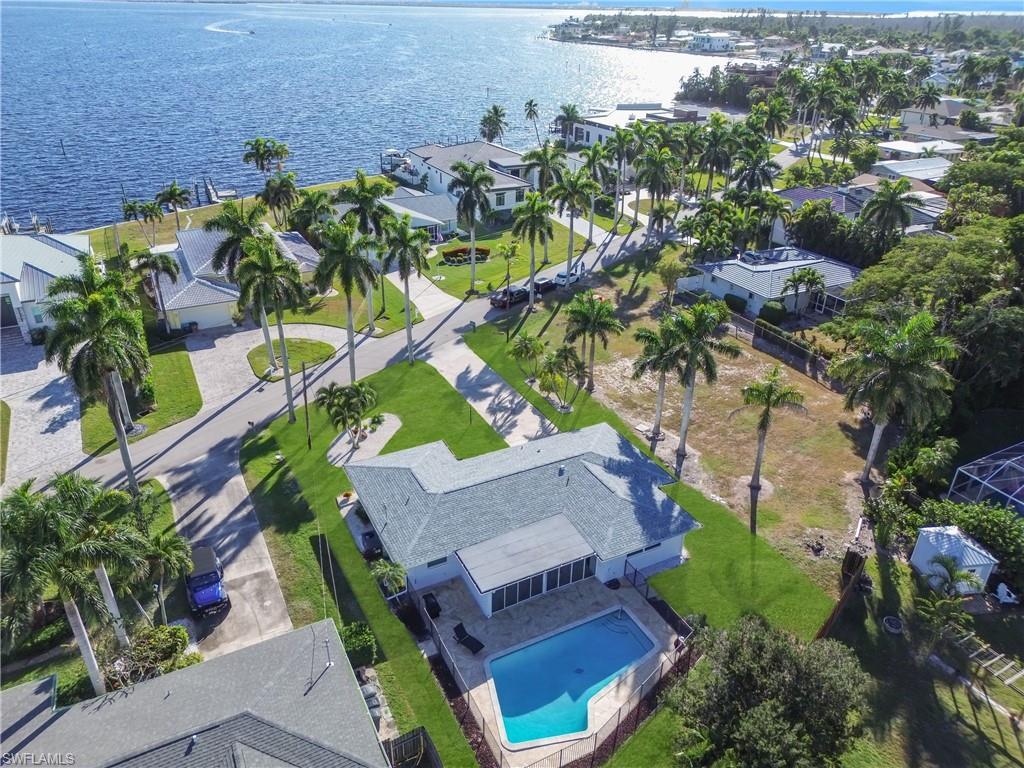 Image 1: Aerial view of residential area with a large body of water