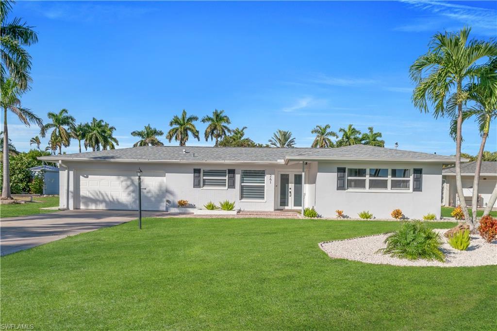 Image 2: Ranch-style house featuring an attached garage, a front yard, concrete driveway, french doors, and stucco siding