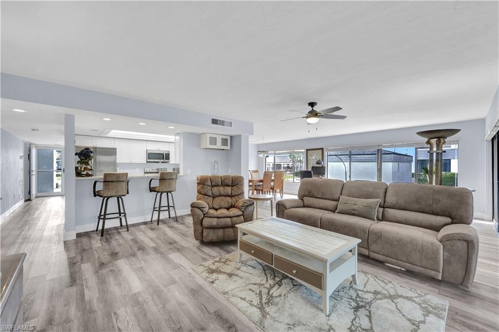 Image 2: Living room featuring a ceiling fan, light wood-style floors, and recessed lighting